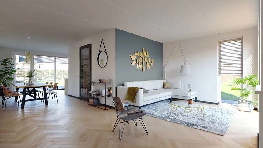 Woonkamer met eettafel en eetstoelen eromheen. Een witte bank en stoel.