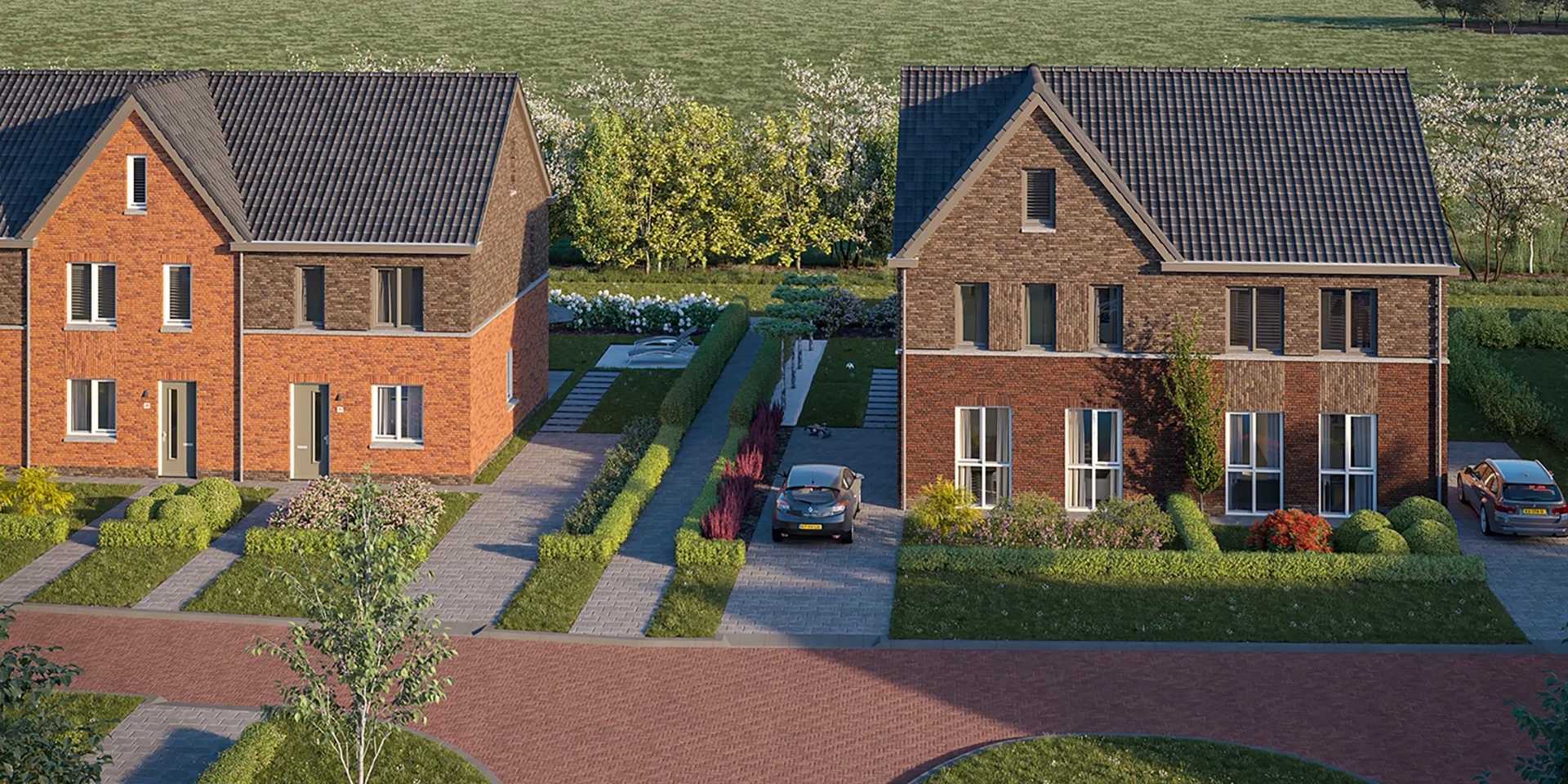 Vooraanzicht van de tweekappers met auto's op de oprit